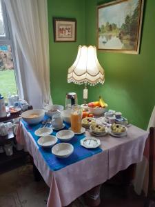 a table topped with plates and bowls of food at Gleneven Guest House in Inniskeen