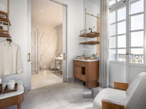a bathroom with a wooden vanity and a mirror at THE DOLLI at Acropolis, A Hotel to Live in Athens +153 photos