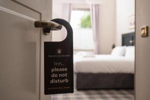 a sign on the door of a room with a bed at Regent Hotel By The Lake in Ambleside