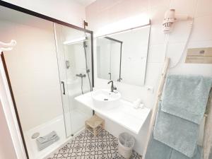a bathroom with a sink and a shower at Blanc Sable Hôtel in Golfe-Juan