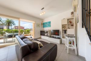 a living room with a couch and a tv at M4R Casa Iuca in Alcudia