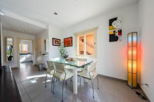 a dining room with a glass table and chairs at M4R Casa Iuca in Alcudia