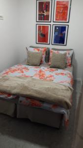 een bed in een kamer met foto's aan de muur bij Villa Marija in Opatija