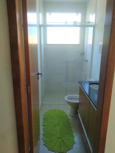 uma casa de banho com um chuveiro, um WC e uma janela. em Cs6 Casa de 3 Quartos a 15min de Curitiba em Campina Grande do Sul