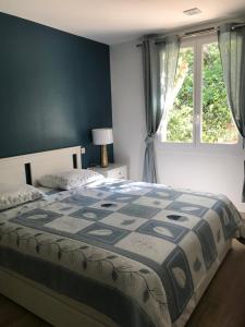 a bedroom with a bed and a window at Neptune in Cavalaire-sur-Mer