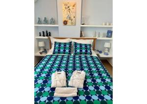 a bedroom with a bed with towels on it at Υπέροχο Διαμέρισμα στους καταρράκτες της Έδεσσας in Edessa
