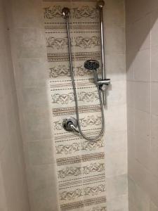 a shower with a hose attached to a wall at Fausthome Sant'Antioco in SantʼAntìoco