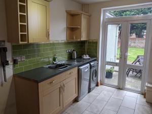 a kitchen with a sink and a washing machine at 3 Newton Street in Bristol