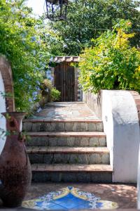 a set of stairs leading to a wooden door at Capri Villa Vittoria by Capri Property in Anacapri