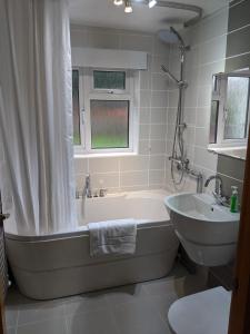 a bathroom with a tub and a sink at 3 Newton Street in Bristol