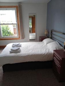 a bedroom with a bed with towels on it at 3 Newton Street in Bristol