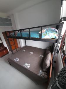 two bunk beds in a room with a bed at Paradise Villa in Gampaha