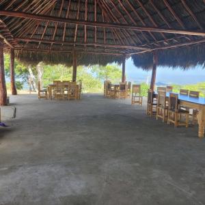 a large pavilion with tables and chairs in it at Ecohotel La Reserva in Piojó