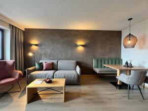 a living room with a couch and a table at Das Grafenstein Familienresidence in Cermes