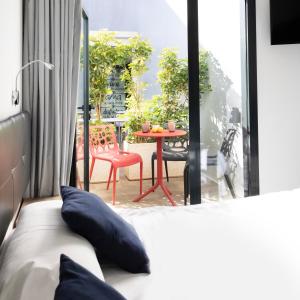 a bedroom with a bed and a patio with a table at Hotel Portmán in Portman