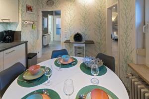a table with plates and glasses on it in a kitchen at Ferienwohnung-Moewenblick in Norden +12 photos