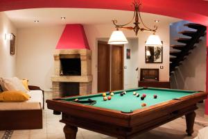a living room with a pool table and a fireplace at La Jarocha, casa con vistas al mar en Pechón in Pechón