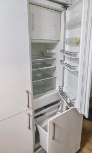 a white refrigerator with its door open with its door openktop at Confort Apartament in Ploieşti