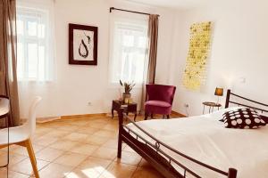 a bedroom with a bed and a table and chairs at Künstler Ferienwohnung am Weilburger Schloss, Marktplatz 9 in Weilburg