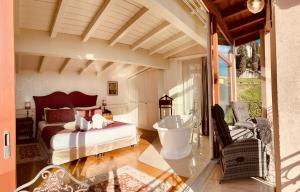 a bedroom with a bed and a tub in it at Relais Colle San Pietro in Verona