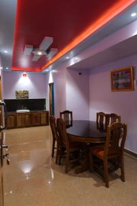 a dining room with a table and chairs at Ammukutty's Cottage in Munnar