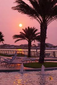 a sunset over a body of water with palm trees at Bella Luna 902-New Rental-3bd/3bath-Upscale Luxury in Orange Beach