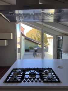 a kitchen with a stove top oven in a kitchen at Luxury Langhe Loft in La Morra