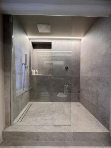 a bathroom with a shower with a glass door at Luxury Langhe Loft in La Morra +56 photos