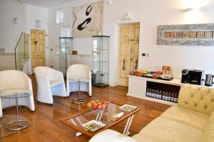 a living room with white chairs and a table at Avanguardia Art Club in Ferrara