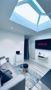 a living room with a couch and a table at Contemporary studio apartment in Pemberton