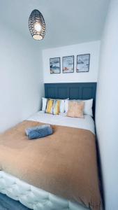 a bedroom with a large bed with pillows on it at Contemporary studio apartment in Pemberton