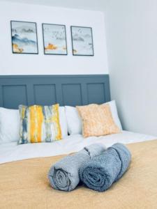 a bed with two towels on top of it at Contemporary studio apartment in Pemberton