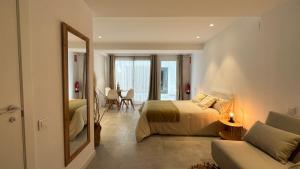 a bedroom with a bed and a mirror and a table at ART HOMES LAVADERO in Valencia