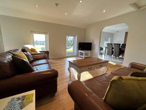 a living room with a couch and a table at Meadow View Apartment in Belcoo