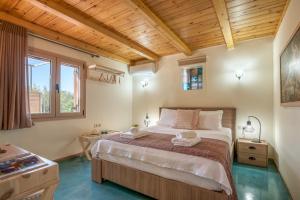 a bedroom with a large bed with a wooden ceiling at Avocado Villa Iason in Chania