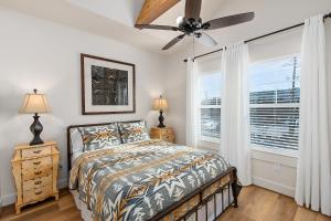 a bedroom with a bed and a ceiling fan at The Lodge Uptown Conroe in Conroe