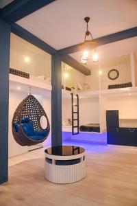 a room with a swing and a room with bunk beds at The Voyage - Cafe Hostel CoWork in Pune