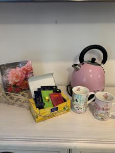 a table with a tea pot and cups on it at Apartman Heidi 4 Sterne in Punat