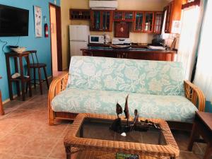 a living room with a couch and a table at Coral Cove Inn in Seine Bight Village
