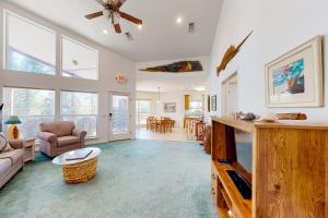 uma sala de estar com uma ventoinha de tecto e uma sala de estar em Seminole Wind em St. George Island