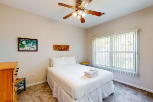 a bedroom with a bed and a ceiling fan at Seminole Wind in St. George Island