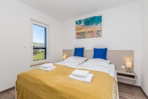 Posteľ alebo postele v izbe v ubytovaní Apartments LUCA