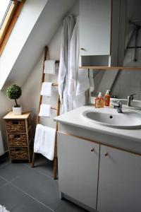 a white bathroom with a sink and a stair at Cœur des chevaux in Deauville