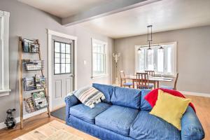 a blue couch in a living room with a table at Aurora Outdoorsy Getaway with Deck and Grill! in Biwabik