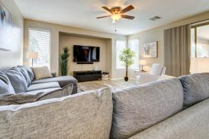 a living room with two couches and a flat screen tv at Updated Gilbert Home with Pool and Community Amenities in Queen Creek