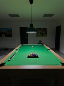 a green pool table with a ball on it at Apartmán Pantáreň in Čadca