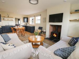 a living room with two couches and a fireplace at Bethania in Oswestry