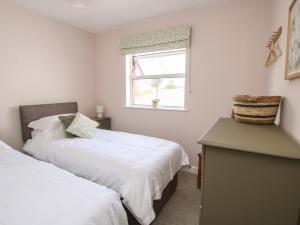 a bedroom with two beds and a window at Bethania in Oswestry