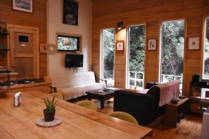 a living room with a couch and a table at Casa Molino de Chiloé in Castro
