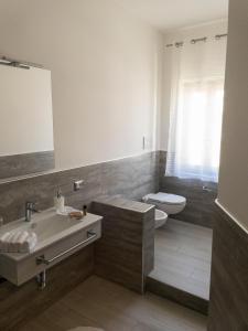 a bathroom with a sink and a toilet at Lamezia Park Apartments in Lamezia Terme
